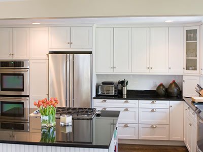 Small kitchen with white cabinets and black quartz island
