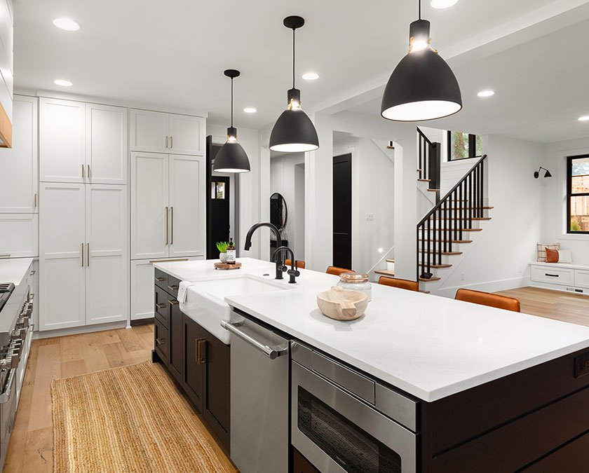 Large kitchen with dark kitchen island and white cabinets