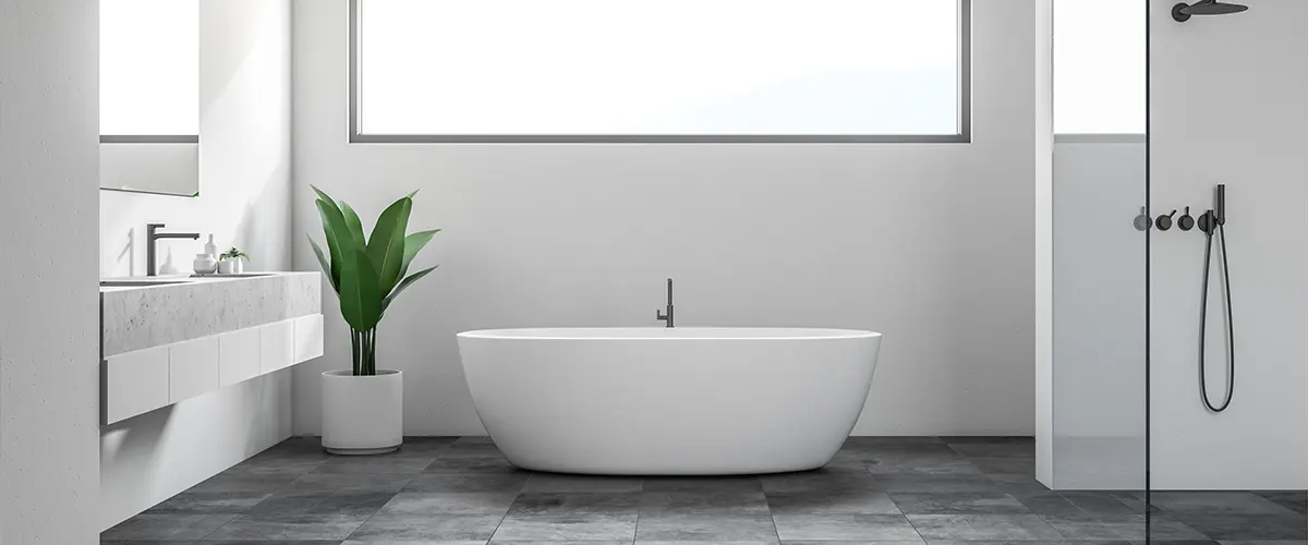 A bathroom with large gray tile flooring