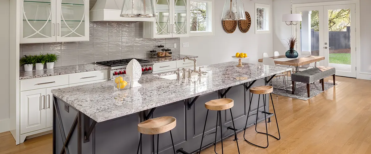 A quartz countertop on a gray kitchen island