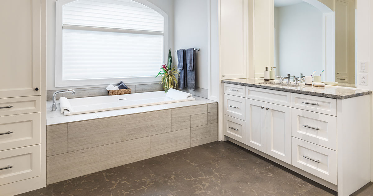 A cozy bath with dark floor and a simple vanity with a bathtub