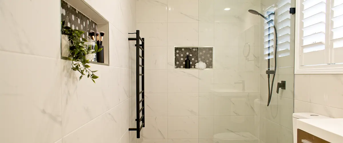 A glass shower conversion with a towel heater rack