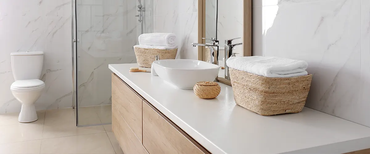 A marble countertop with two wood baskets on it