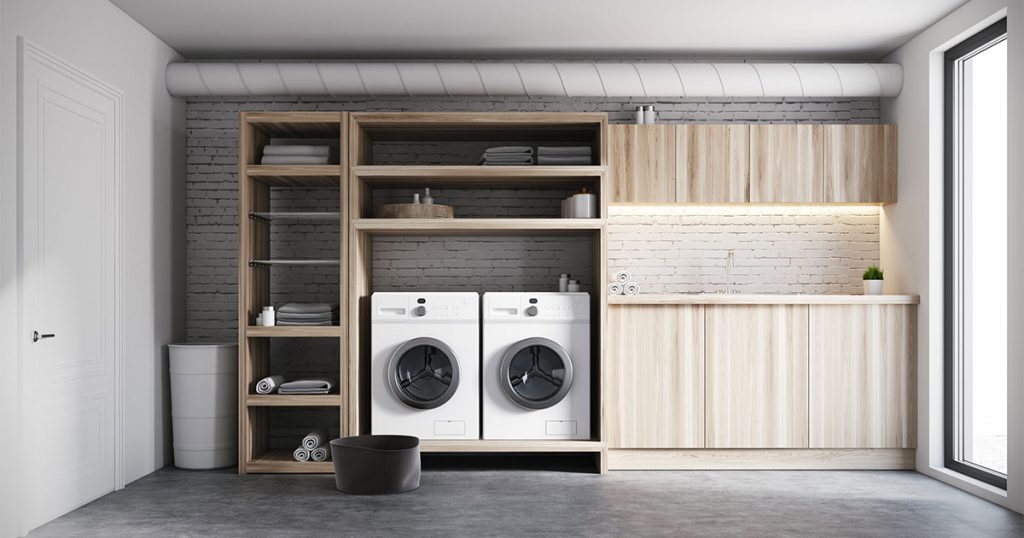 The best laundry room renovation with wood cabinets and two washers