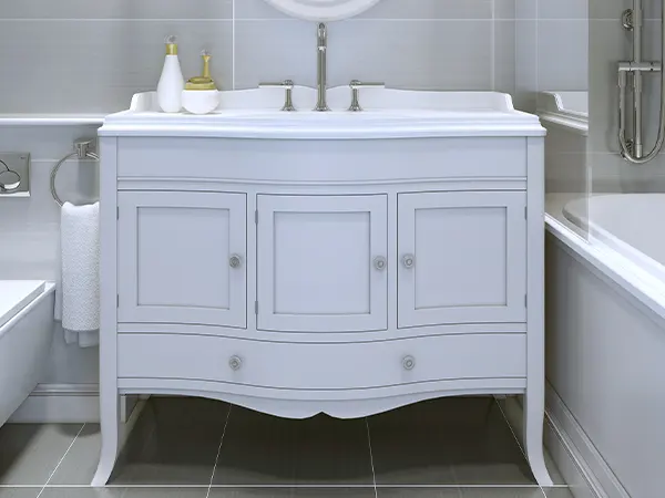 A white simple vanity with decorative elements and hardware