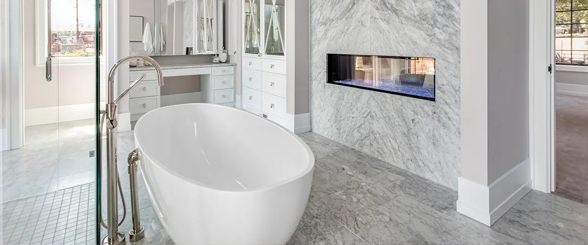 A freestanding tub with large tile floor for a bathroom renovation cost project