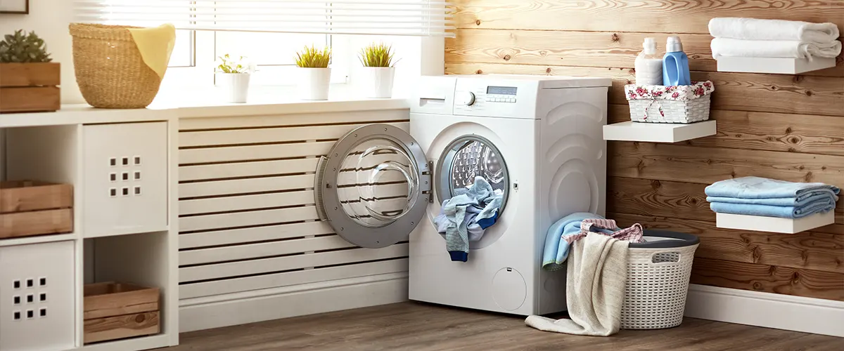 A well-lit laundry room with wood floor and walls
