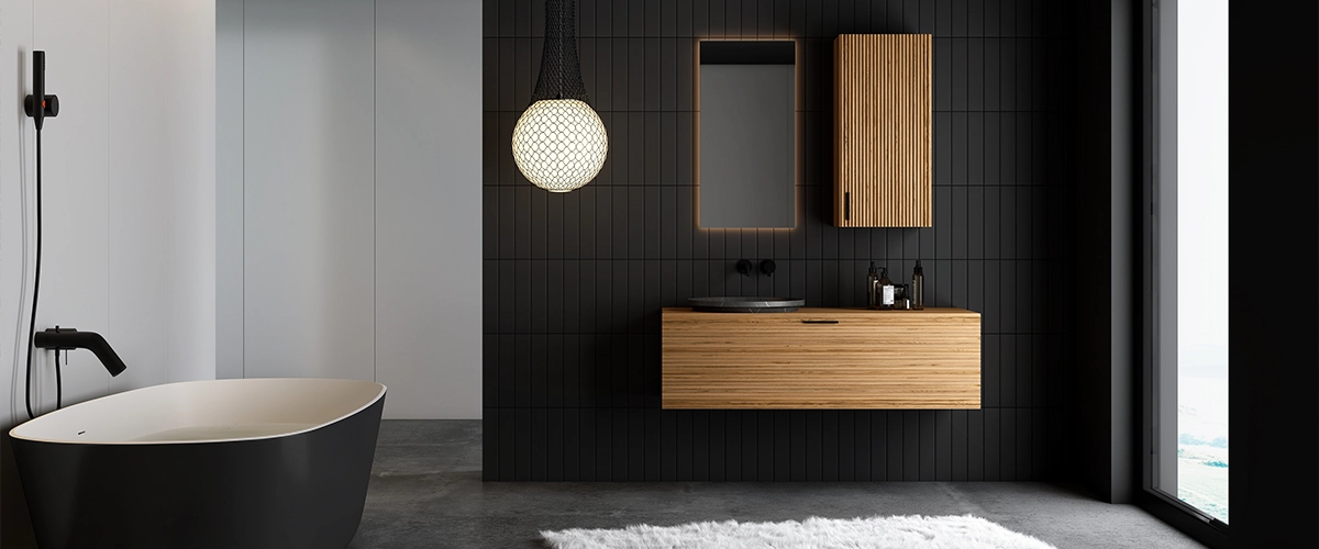 A dark bathroom with wood cabinets and vanity