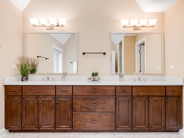 A wood double vanity with two square mirrors