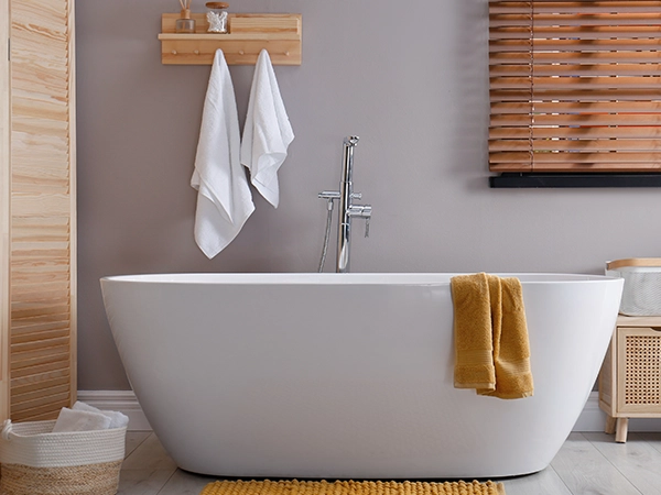 A free standing tub with orange accents