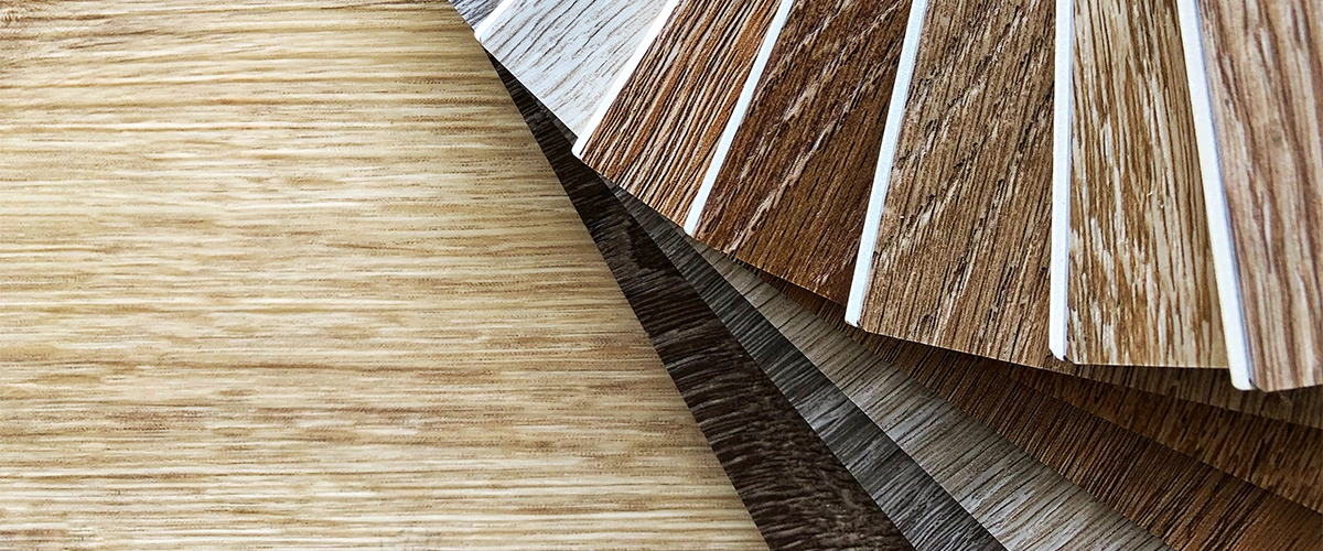 Multiple types of LVP flooring in brown hues