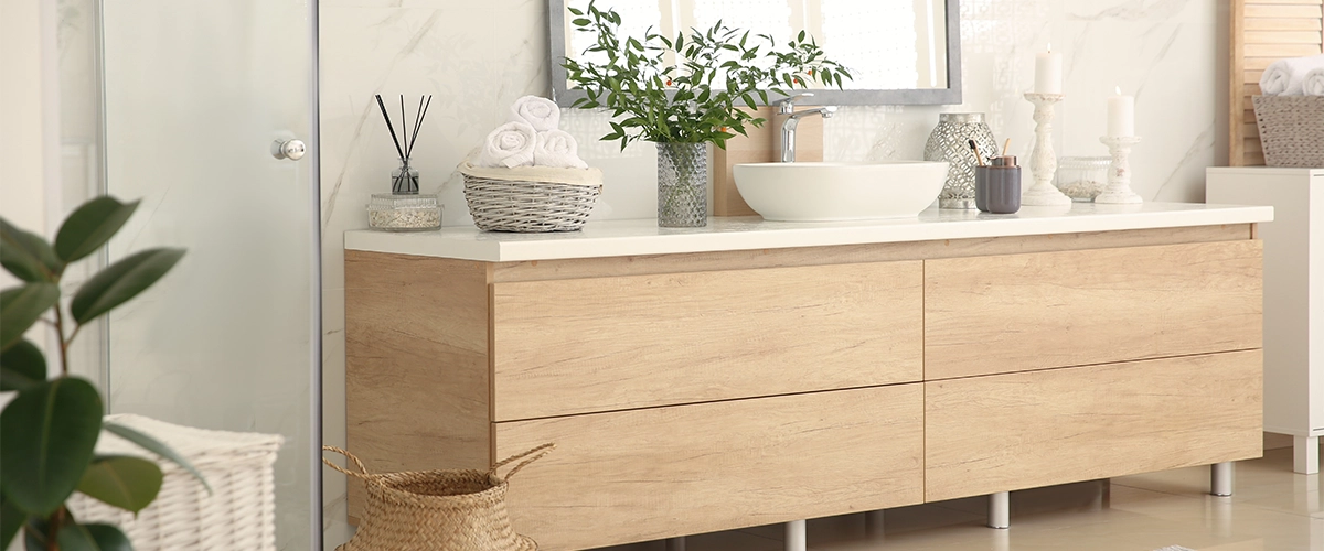 Beautiful modern cabinets made of wood in a bathroom with plants