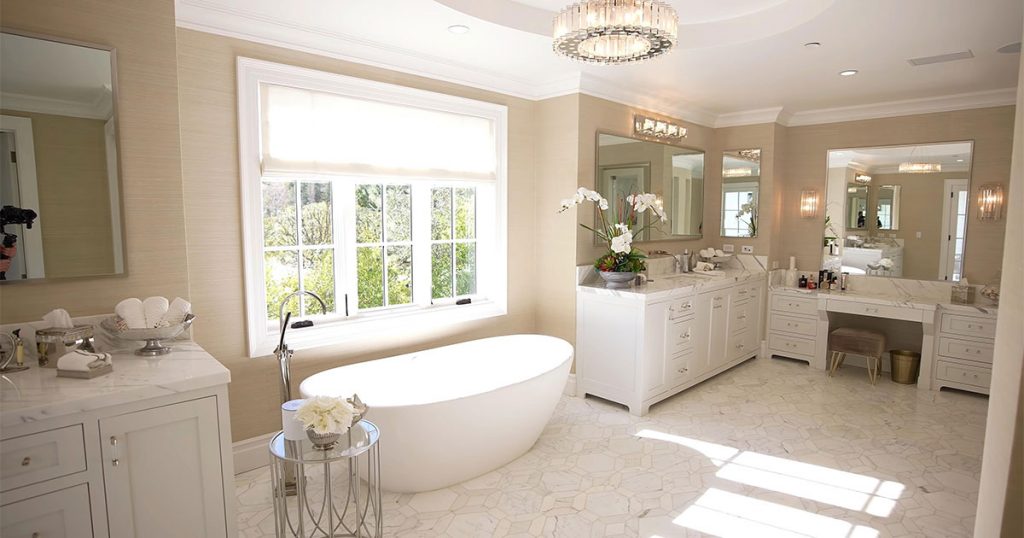 A large bathroom with many vanities and cabinets
