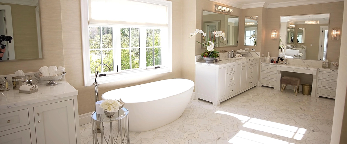 A large bathroom with many vanities and cabinets