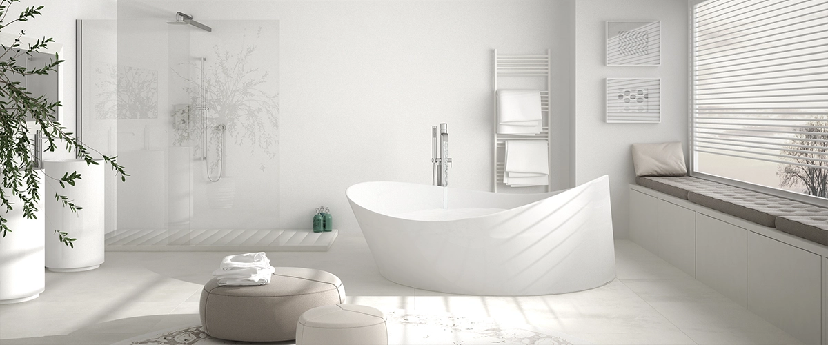 A white bath with a free standing tub and a comfortable chair
