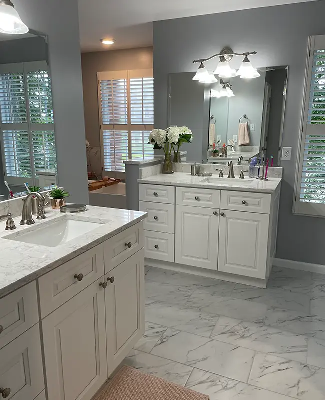Bathroom remodel with cabinet refinishing and porcelain tile with gray walls