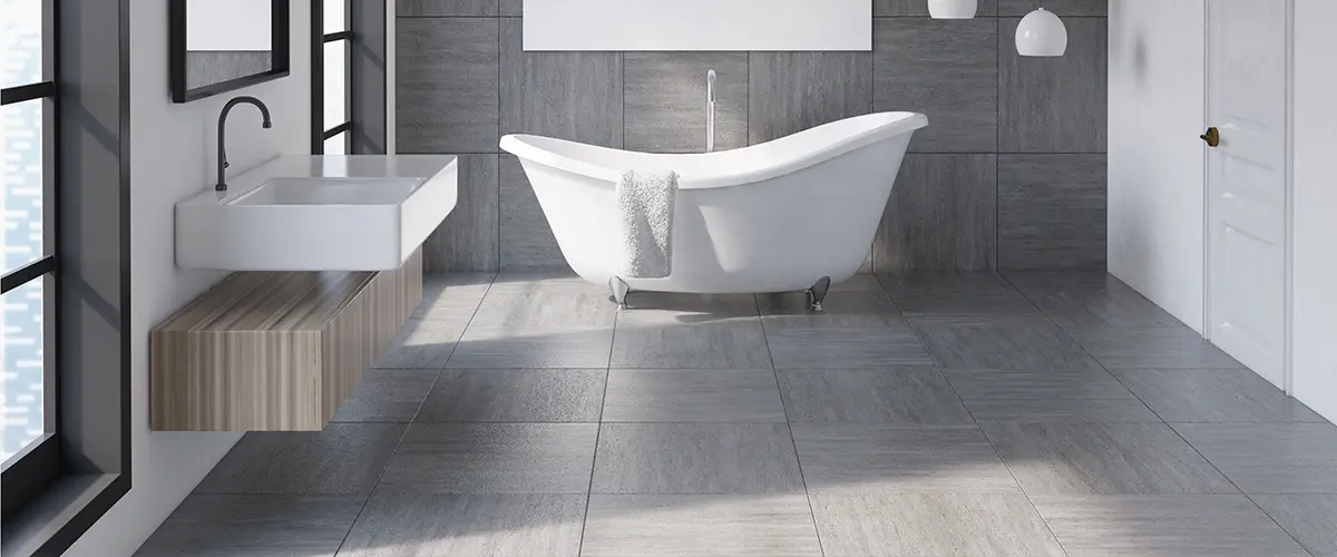 Tile flooring in a large bathroom with a freestanding tub