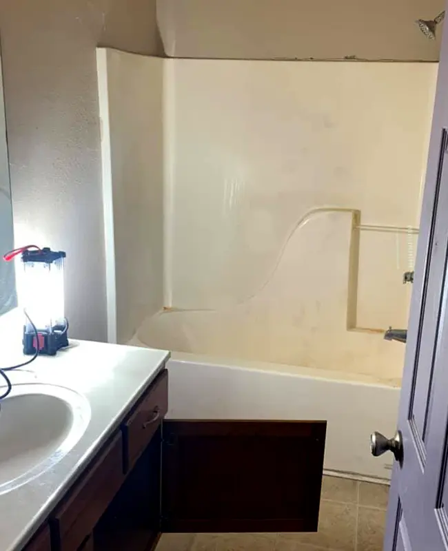 Small hall bathroom with old tub and shower panel