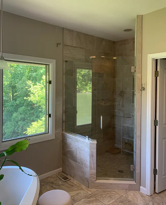 Modern shower with glass enclosure and gray marble tile