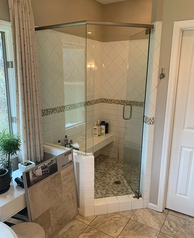 Outdated white tile curb shower with glossy tile