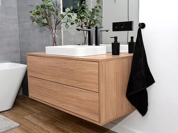 A beautiful, simple wood vanity with no pulls or knobs