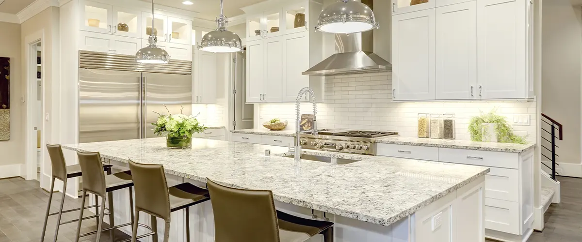 White cabinets with white countertops made of granite